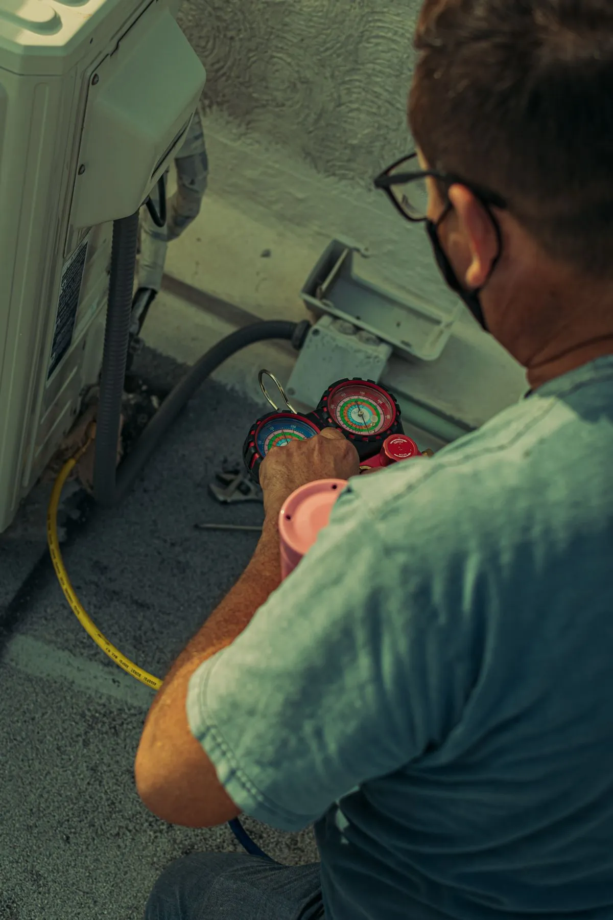Technician checking an outdoor air conditioning unit